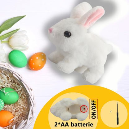 White plush bunny toy with Easter eggs and a nest on a light gray background